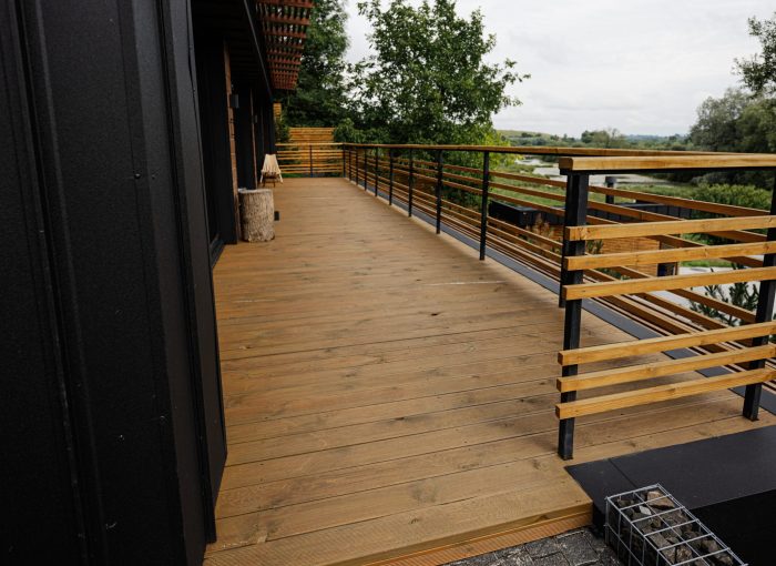 Wooden terrace of modern wood stone house.